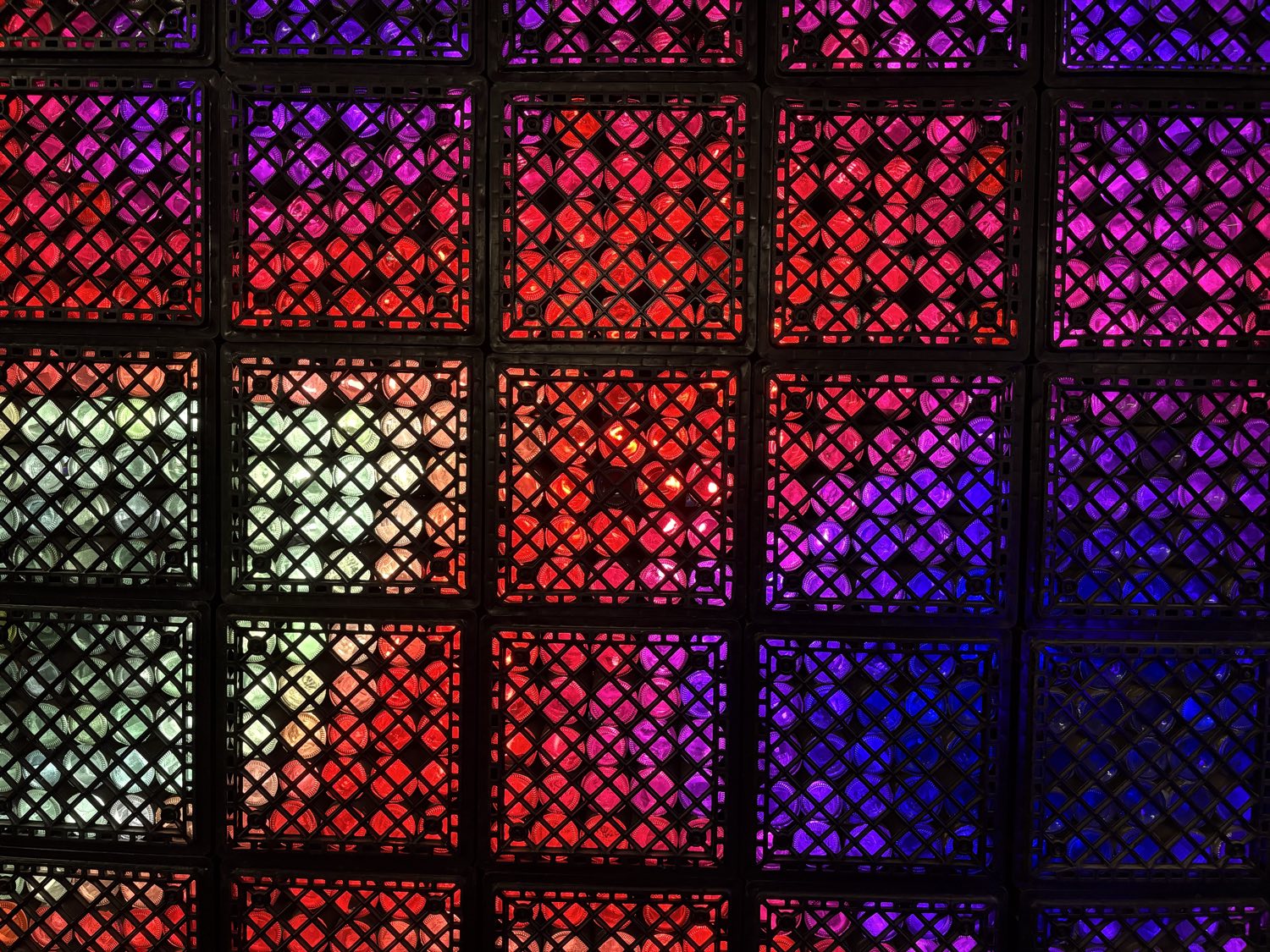 The FlaschenTaschen LED wall lit up, its crates glowing in red, blue, green, and magenta